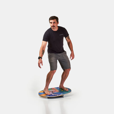 Man on the Indo balance board featuring The Original model and flow cushion.
