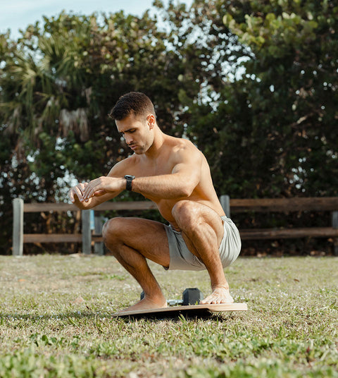 joey miuccio doing a squat on an indo board